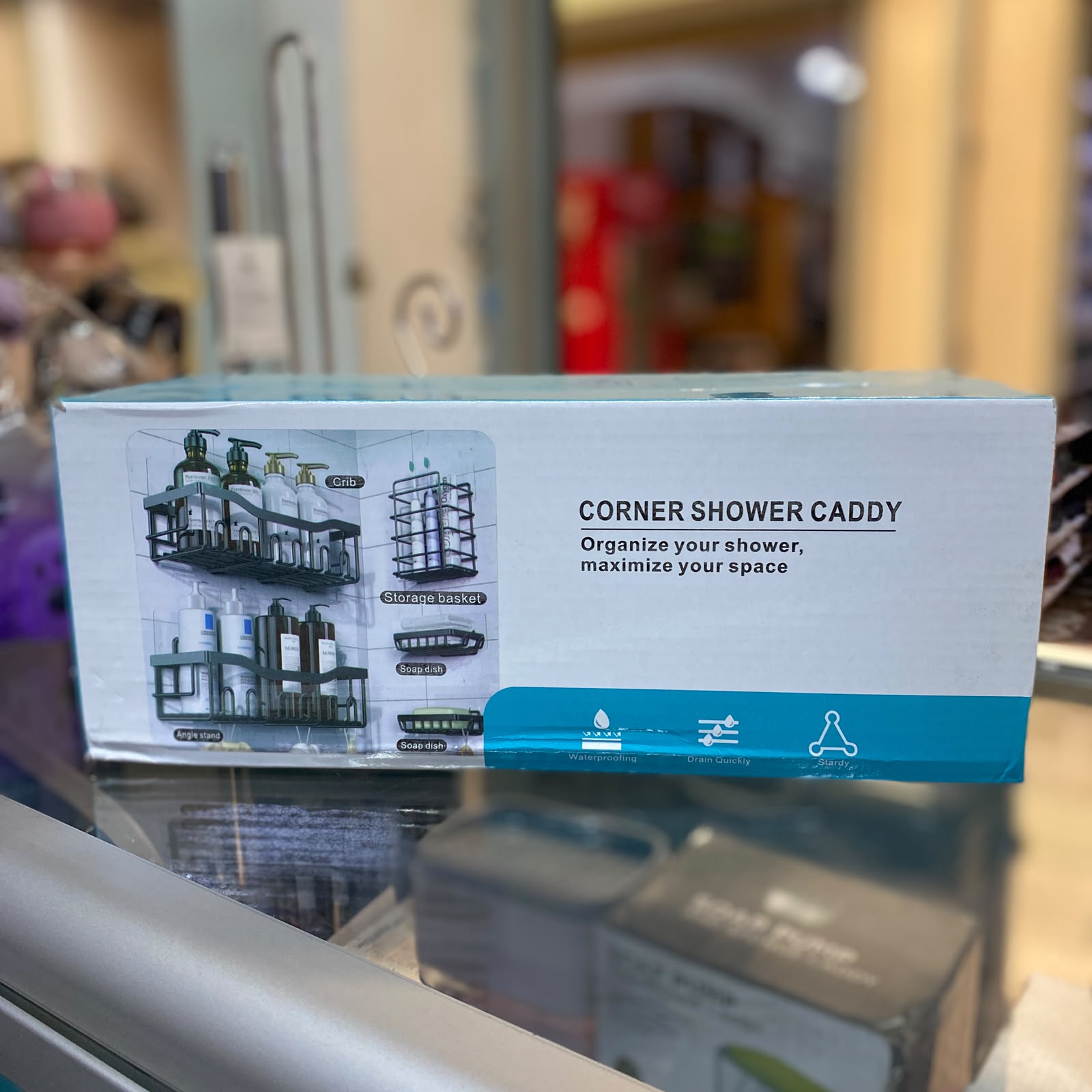 Adhesive shower shelf